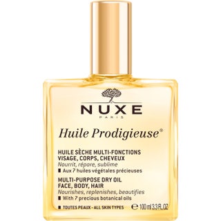 Nuxe Huile Prodigieuse 100 ml dry oil ger näring i en fyrkantig glasflaska med glansig guldkork.