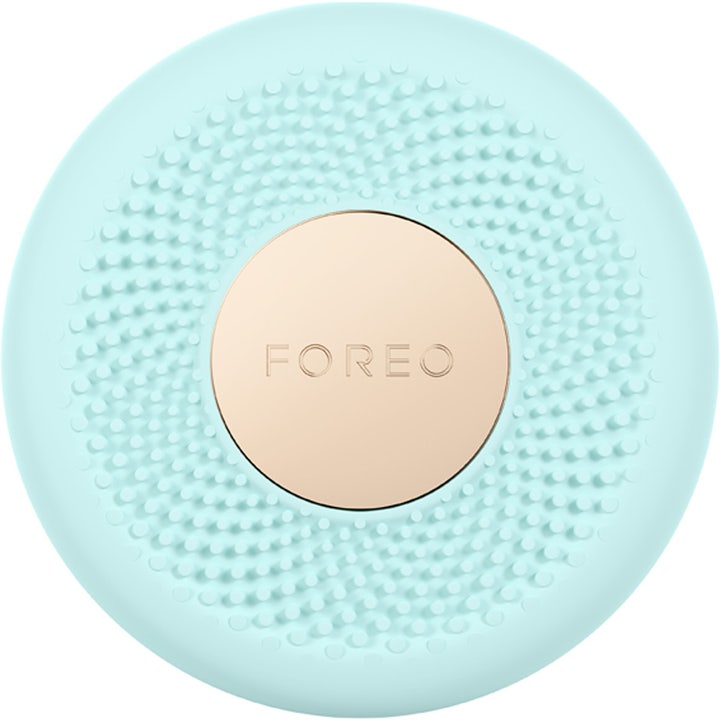 FOREO UFO för led ljusterapi och hemma spa är ett mintgrönt cirkulärt hudvårdsverktyg i silikon med guldplatta.