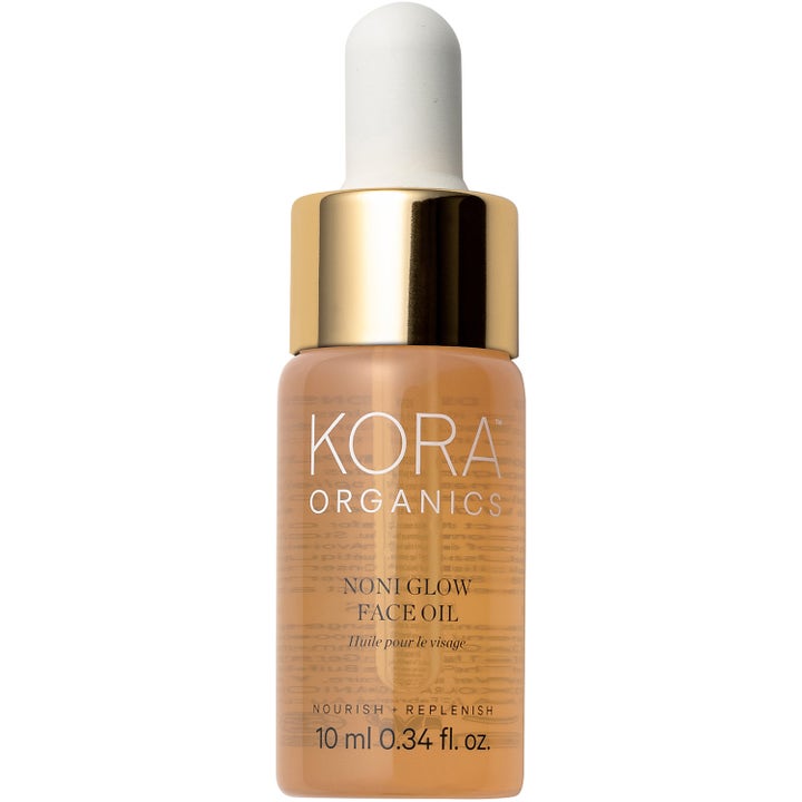 Kora Organics Noni Glow Face Oil 10 ml ekologisk ansiktsolja för lyster i liten glasflaska med guldlock och pipett.