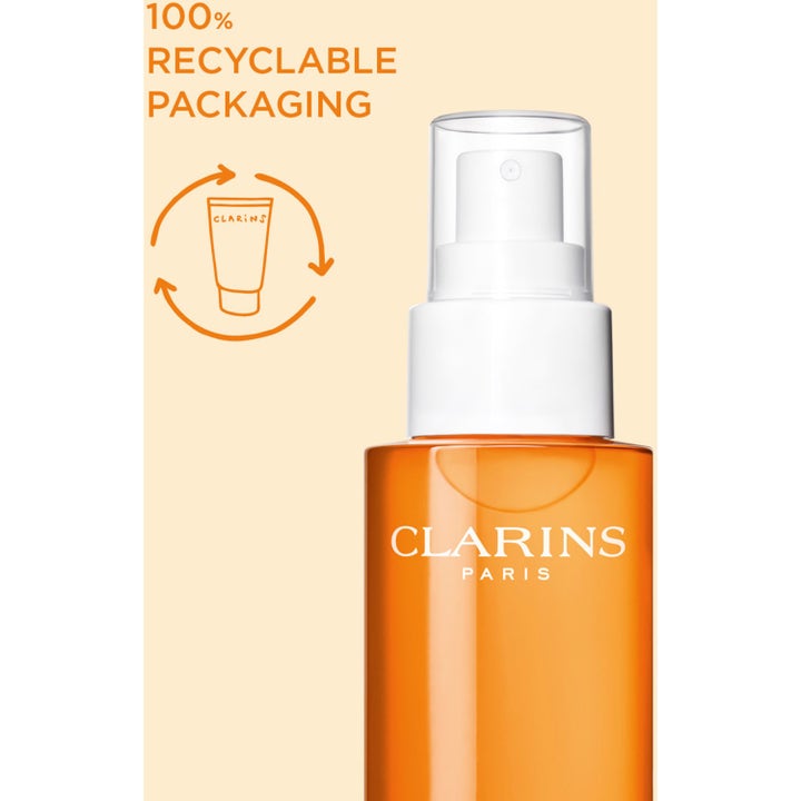 Clarins Glowing Sun Care Mist 150 ml icke-kladdig solspray kropp i orange flaska märkt som återvinningsbar